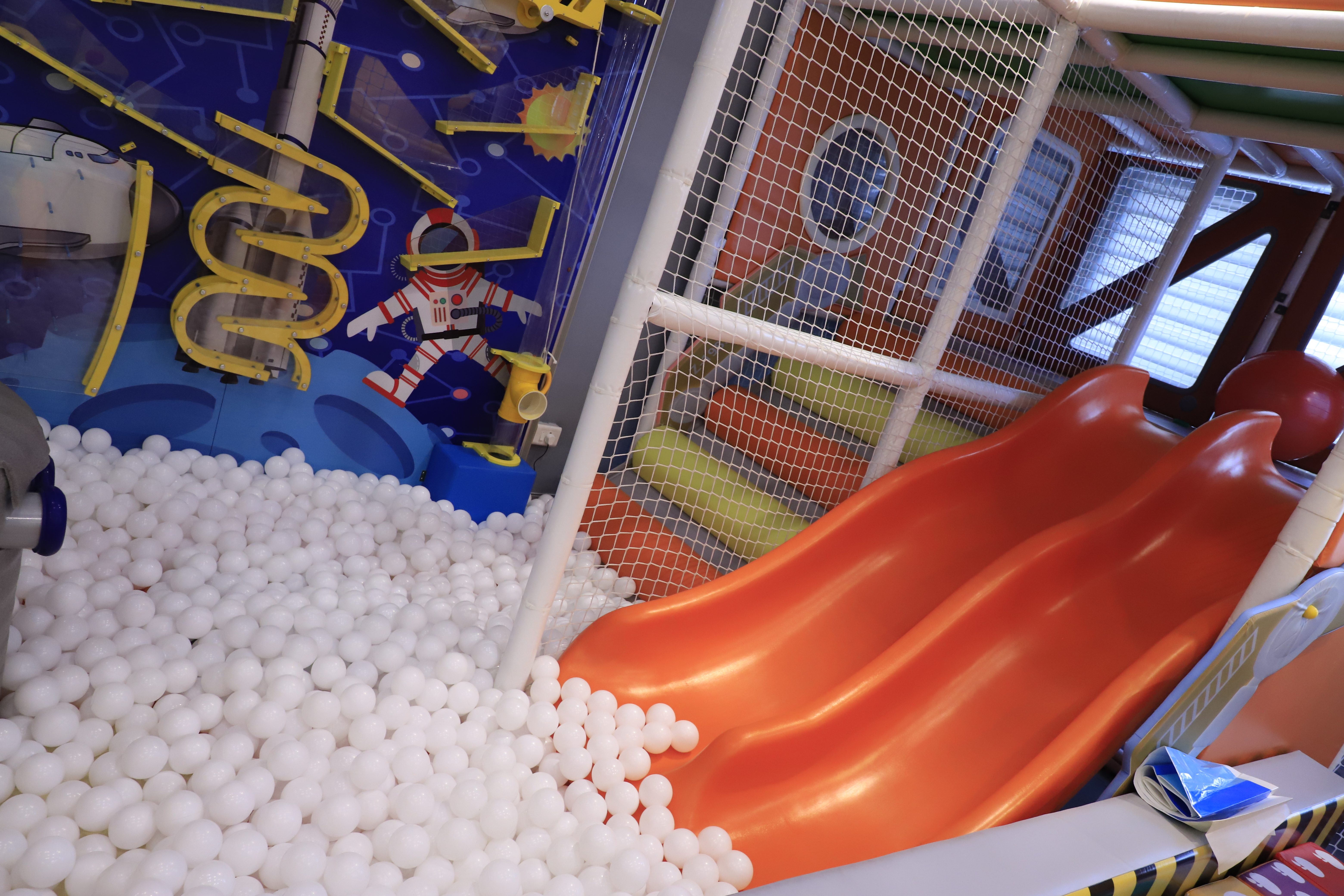 Colourful slides and ball pool inside tingaland