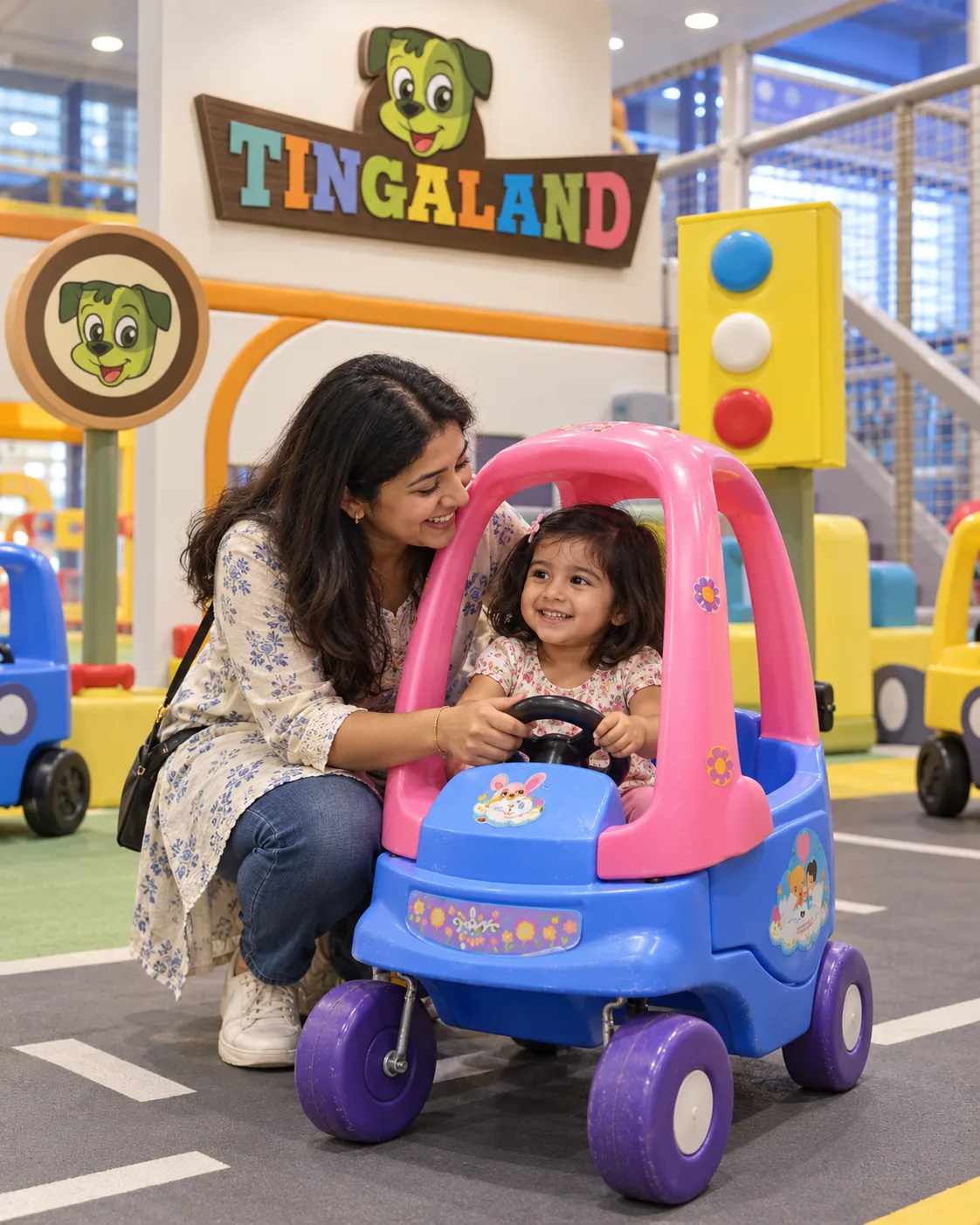 Parent guiding a toddler in a tingaland kiddy car