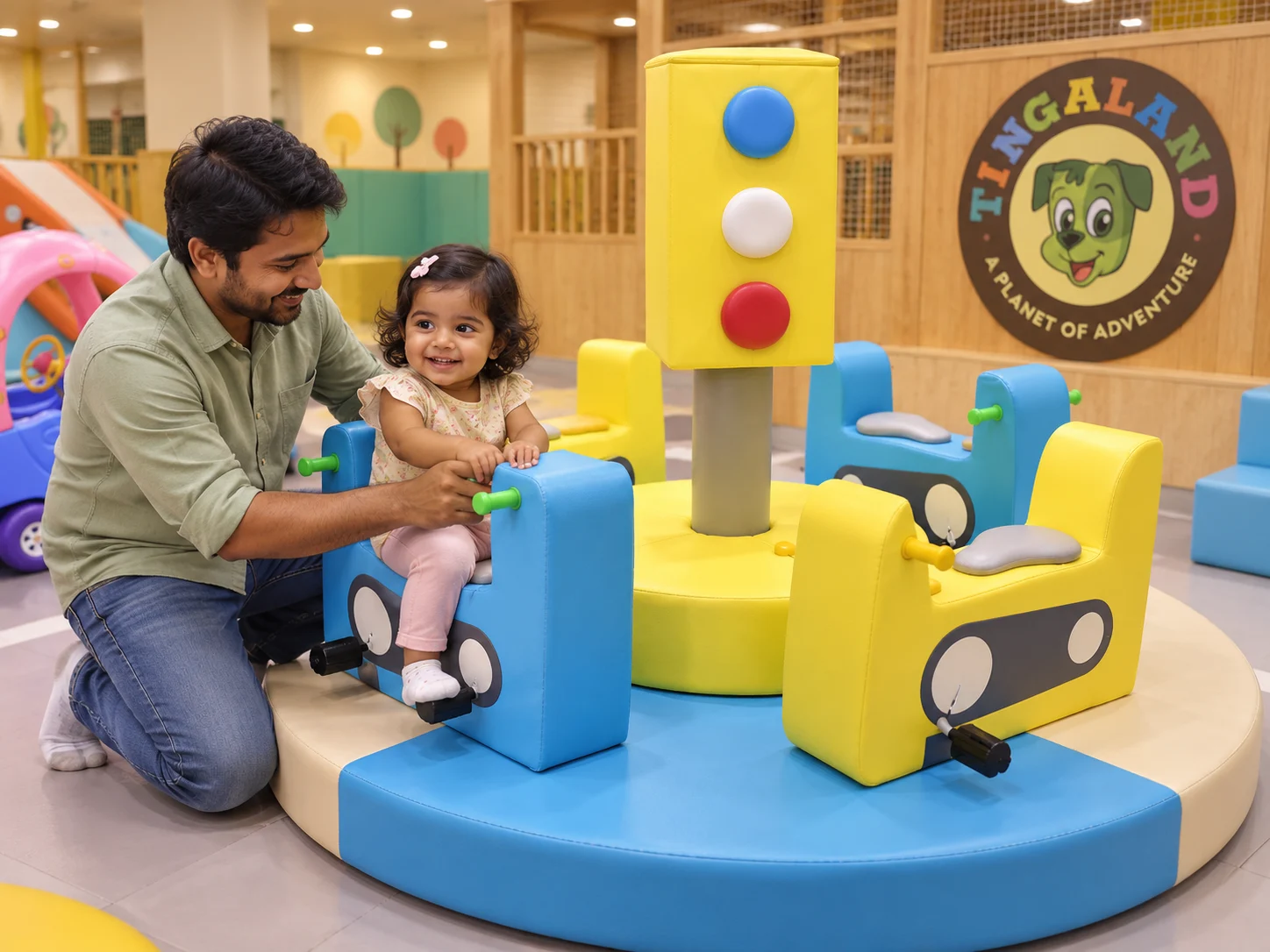 Father helping his toddler settle into the tingaland ride