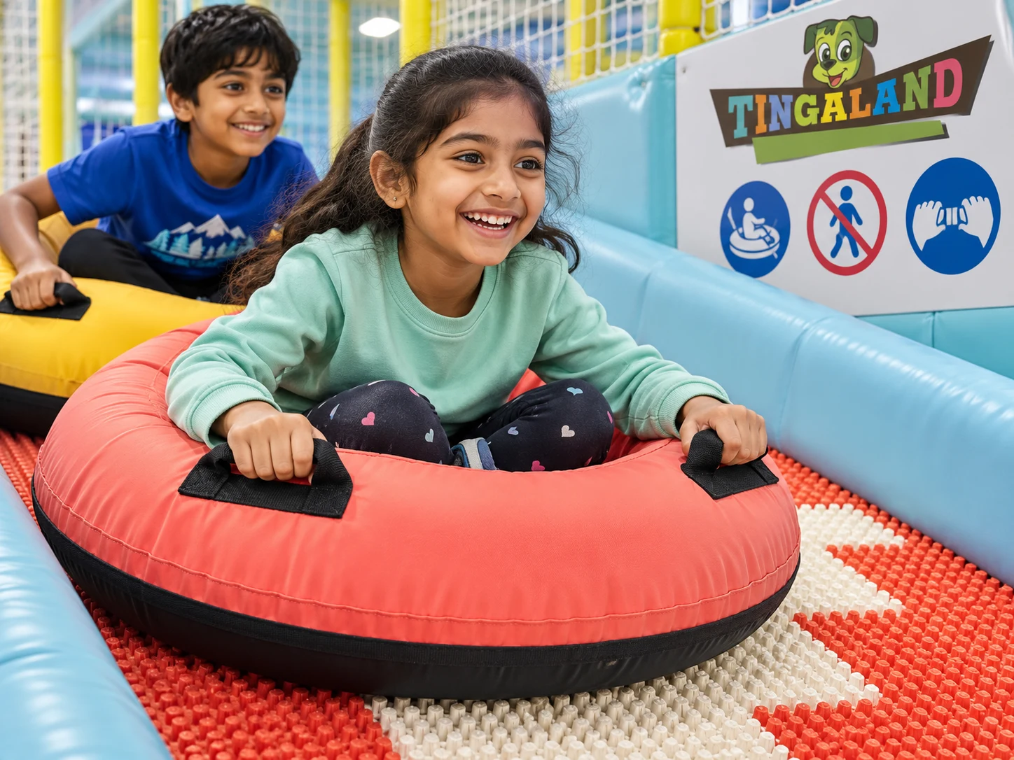 Close view of children holding safe handles on colourful donut rings