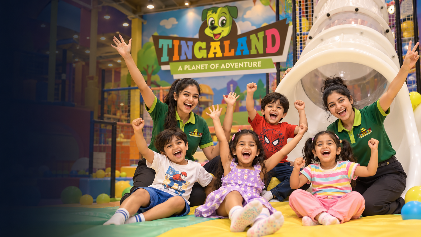 Children and tingaland team members celebrating near the tube slide