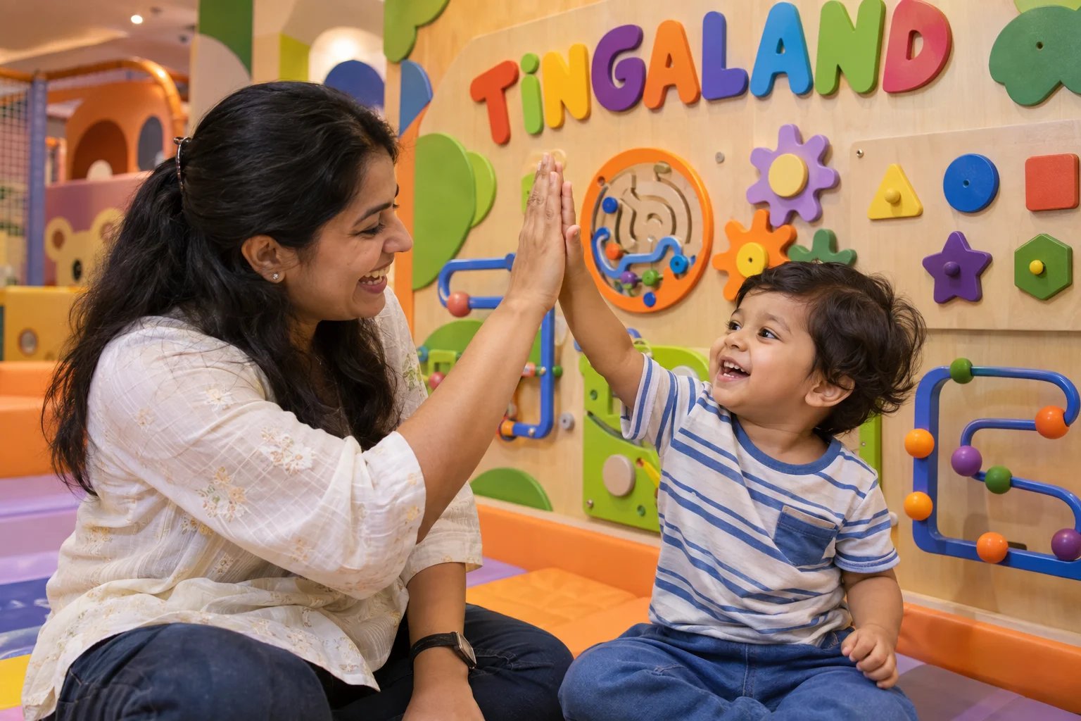 Toddler and parent celebrating a wall puzzle at tingaland